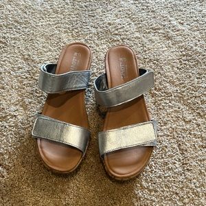 Naot brand women’s silver/cork sandal with adjustable straps.
